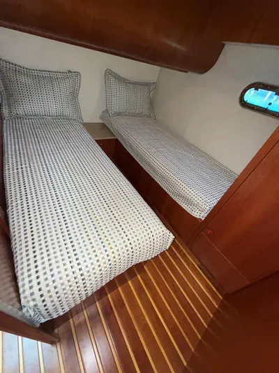 Shelly Anne Yacht Photos Pics Twin beds in 2000 Tiara Yachts 5200 Express cabin with wooden flooring.