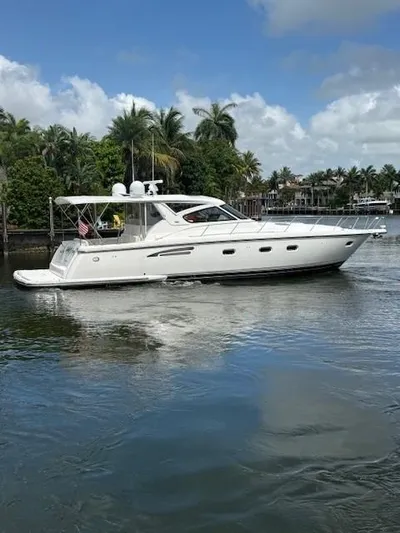 Shelly Anne Yacht Photos Pics 2000 Tiara Yachts 5200 Express cruising on a serene waterway with palm trees.