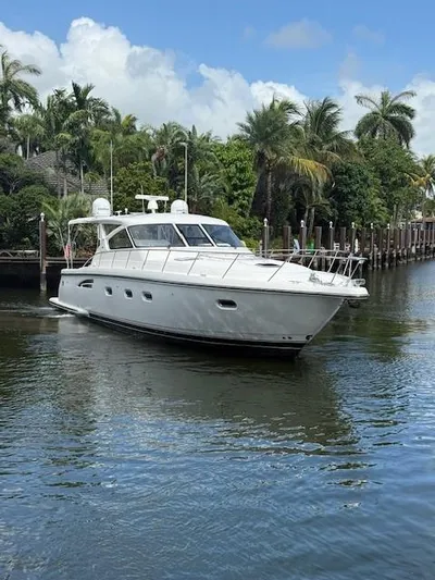 Shelly Anne Yacht Photos Pics 2000 Tiara Yachts 5200 Express cruising on a tropical waterway with palm trees.