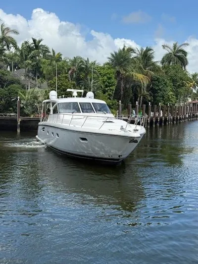 Shelly Anne Yacht Photos Pics 2000 Tiara Yachts 5200 Express cruising on a tropical waterway with palm trees.