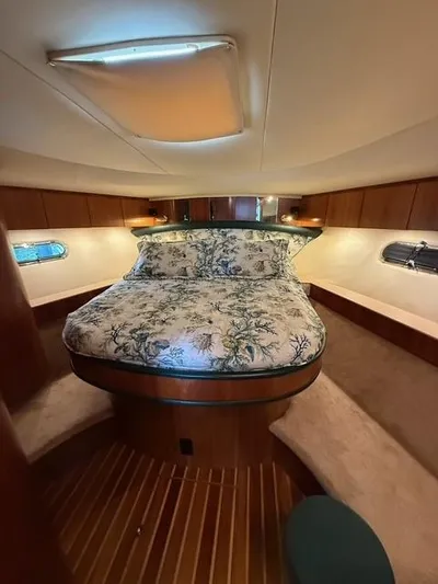 Shelly Anne Yacht Photos Pics Luxurious cabin interior of 2000 Tiara Yachts 5200 Express with elegant bedding and wood finishes.
