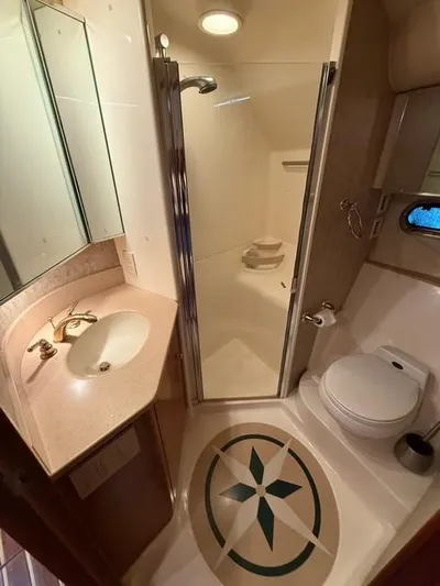 Shelly Anne Yacht Photos Pics Bathroom interior of 2000 Tiara Yachts 5200 Express with shower, sink, and toilet.