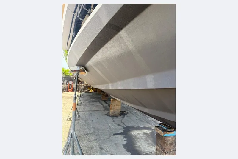 Shelly Anne Yacht Photos Pics 2000 Tiara Yachts 5200 Express hull on dry dock, supported by stands.