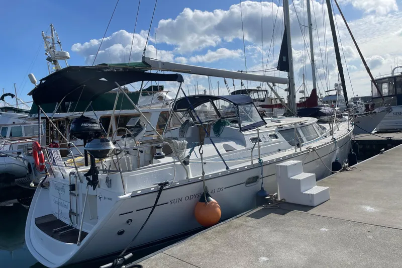 "dragonfly" Yacht Photos Pics 2003 Jeanneau Sun Odyssey 43 DS sailboat docked at marina under blue sky.