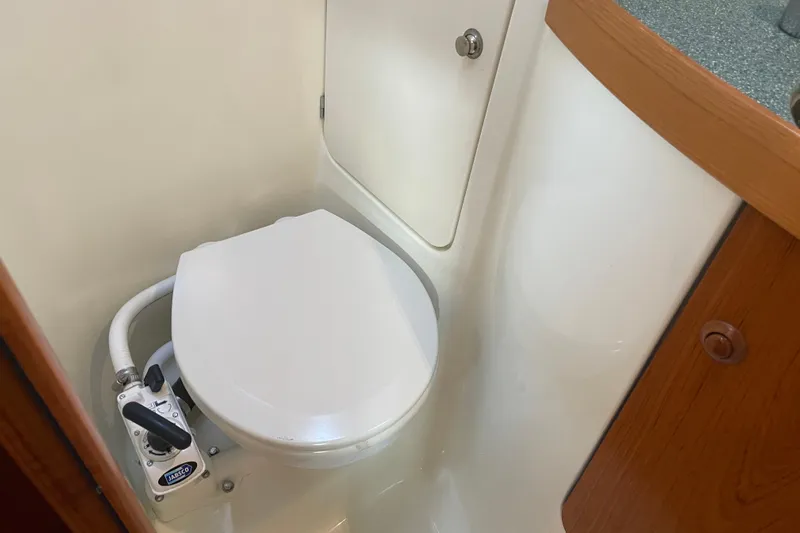 "dragonfly" Yacht Photos Pics 2003 Jeanneau Sun Odyssey 43 DS yacht bathroom with marine toilet and storage.