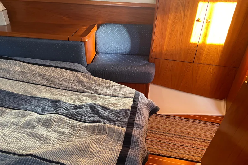 "dragonfly" Yacht Photos Pics Cozy cabin interior of 2003 Jeanneau Sun Odyssey 43 DS sailboat with wooden furnishings.