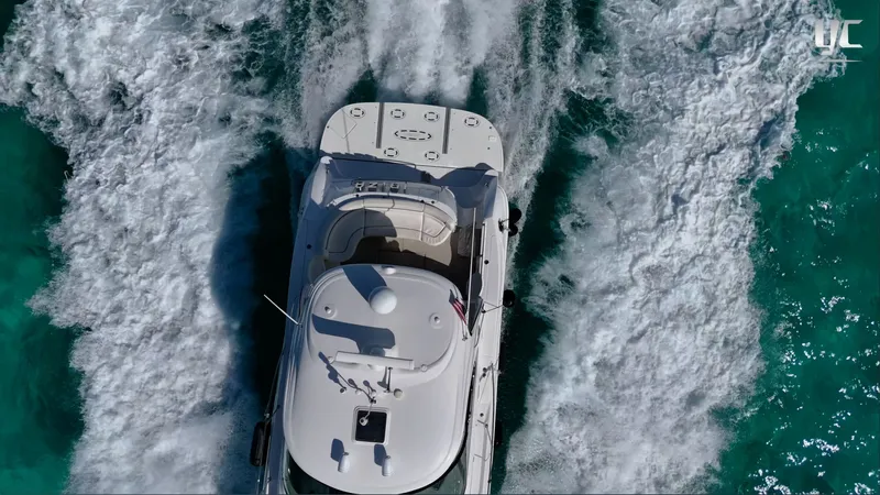  Yacht Photos Pics Aerial view of 2006 Sea Ray 52 Sundancer yacht cruising through turquoise waters.