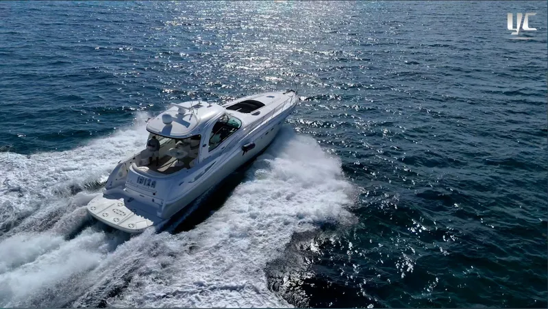  Yacht Photos Pics 2006 Sea Ray 52 Sundancer cruising on open water, creating a wake.