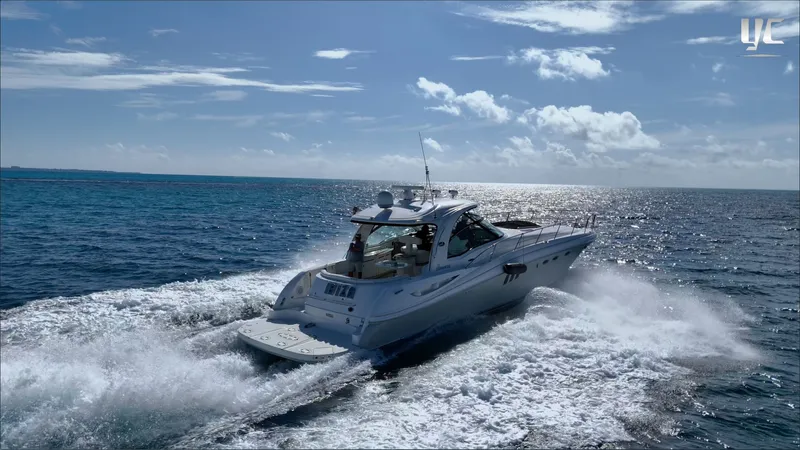  Yacht Photos Pics 2006 Sea Ray 52 Sundancer cruising on open ocean under clear blue sky.