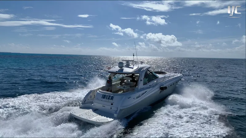  Yacht Photos Pics 2006 Sea Ray 52 Sundancer yacht cruising on open ocean under clear blue sky.