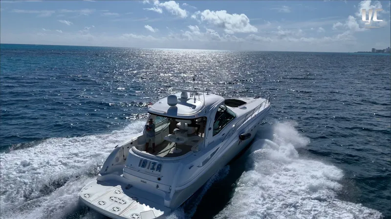  Yacht Photos Pics 2006 Sea Ray 52 Sundancer cruising on open ocean under clear blue sky.