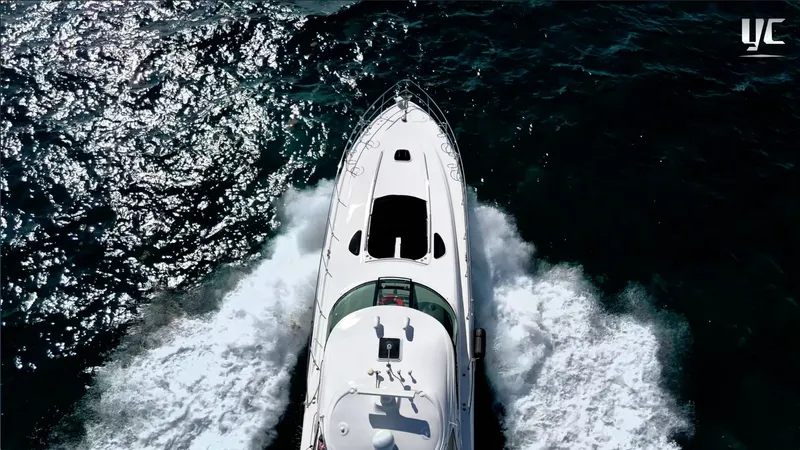  Yacht Photos Pics Aerial view of 2006 Sea Ray 52 Sundancer yacht cruising on open water.