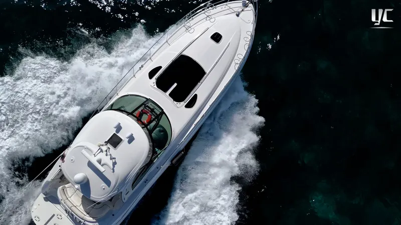  Yacht Photos Pics Aerial view of 2006 Sea Ray 52 Sundancer yacht cruising on open water.