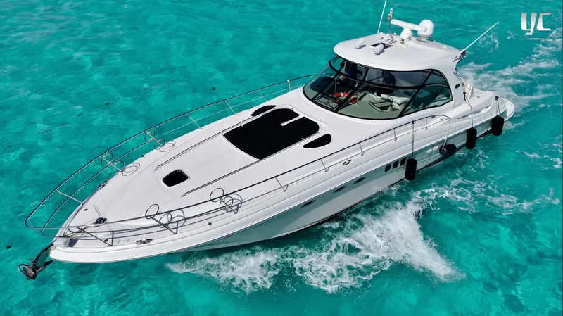  Yacht Photos Pics 2006 Sea Ray 52 Sundancer yacht cruising on clear turquoise waters.