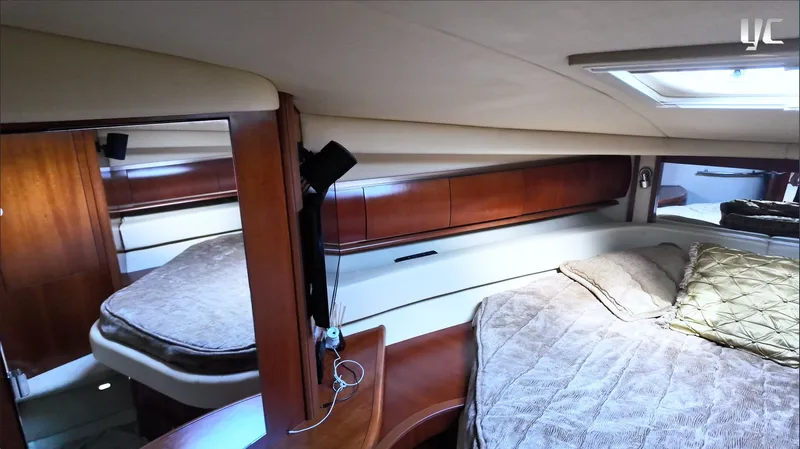  Yacht Photos Pics Luxurious cabin interior of 2006 Sea Ray 52 Sundancer yacht with plush bedding and wood accents.