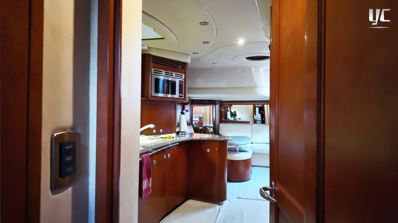  Yacht Photos Pics Luxurious interior of 2006 Sea Ray 52 Sundancer yacht with modern kitchen and seating area.