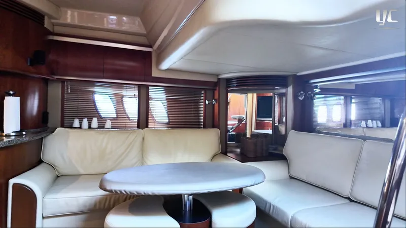  Yacht Photos Pics Interior of 2006 Sea Ray 52 Sundancer yacht with cream leather seating and wooden accents.