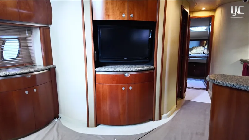  Yacht Photos Pics Luxurious interior of 2006 Sea Ray 52 Sundancer yacht with wood cabinetry and TV.