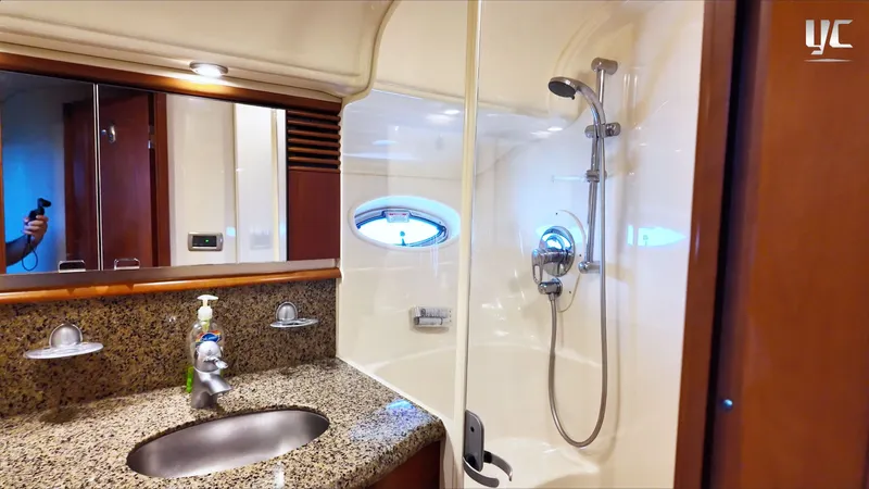  Yacht Photos Pics Luxurious bathroom in 2006 Sea Ray 52 Sundancer yacht with granite countertop and modern shower.