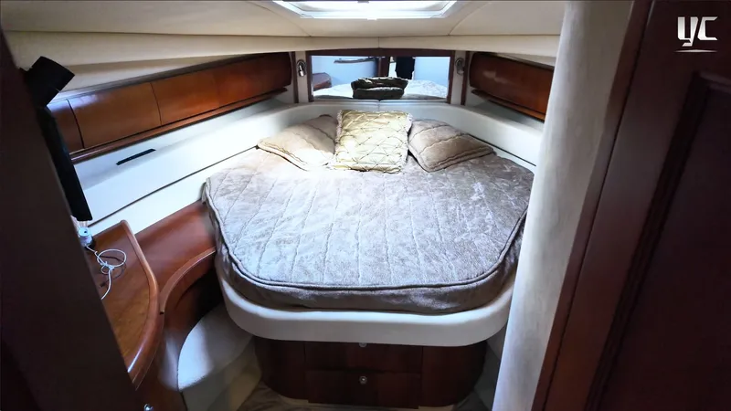  Yacht Photos Pics Luxurious cabin interior of 2006 Sea Ray 52 Sundancer yacht with cozy bed and wooden accents.