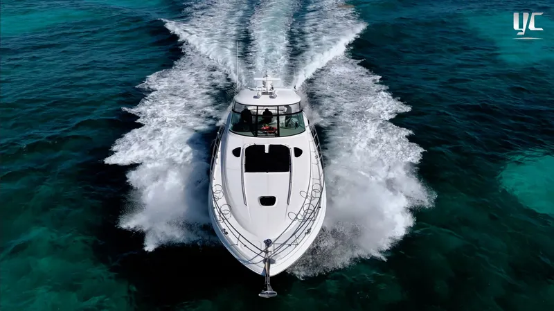  Yacht Photos Pics 2006 Sea Ray 52 Sundancer cruising on clear blue ocean waters.