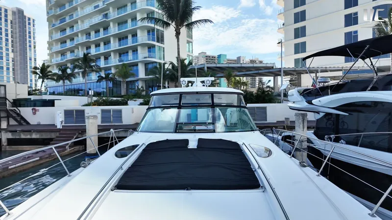  Yacht Photos Pics Luxury 2006 Sea Ray 52 Sundancer yacht docked near modern waterfront buildings.