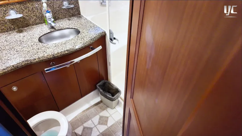  Yacht Photos Pics Luxurious bathroom in 2006 Sea Ray 52 Sundancer yacht with granite countertop and wooden cabinetry.