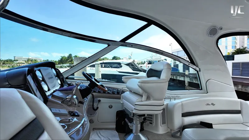  Yacht Photos Pics Interior view of 2006 Sea Ray 52 Sundancer yacht cockpit with luxurious seating and controls.