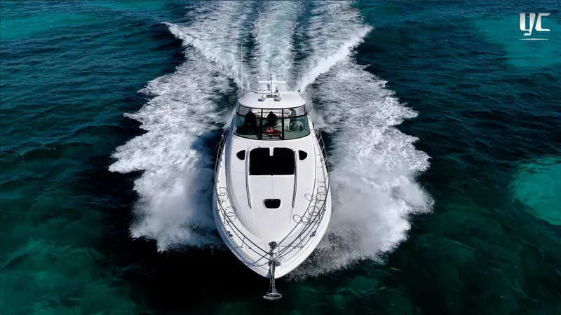  Yacht Photos Pics 2006 Sea Ray 52 Sundancer cruising on clear turquoise waters.