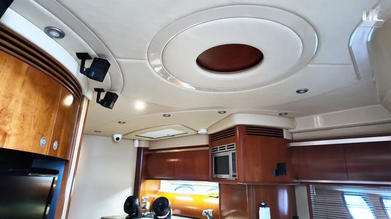  Yacht Photos Pics Luxurious interior of 2006 Sea Ray 52 Sundancer yacht with modern wood cabinetry and ceiling design.