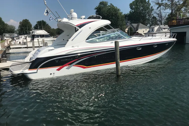  Yacht Photos Pics 2007 Formula 400 Super Sport boat docked in a marina, surrounded by water and trees.
