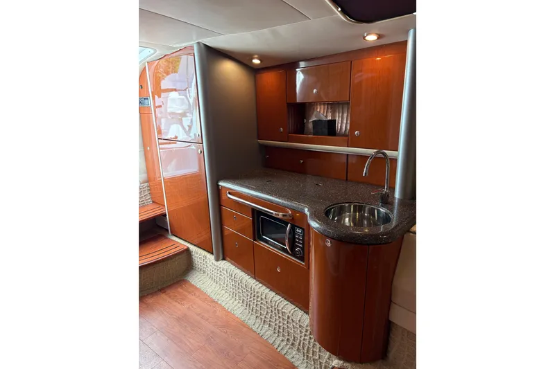  Yacht Photos Pics Luxurious 2007 Formula 400 Super Sport yacht interior kitchen with wood cabinetry and modern appliances.