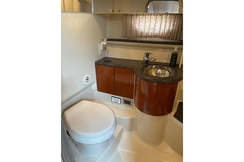  Yacht Photos Pics 2007 Formula 400 Super Sport yacht bathroom with sink, toilet, and wooden cabinetry.