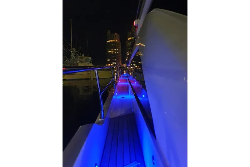 Kamats Yacht Photos Pics Night view of 2010 Fairline Squadron 55 yacht with blue deck lights.