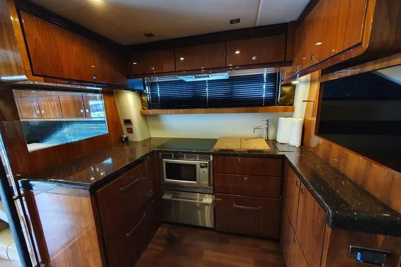 Kamats Yacht Photos Pics Luxurious kitchen interior of 2010 Fairline Squadron 55 yacht with wood cabinetry and modern appliances.