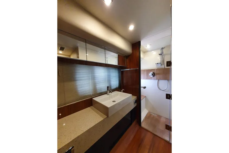 Kamats Yacht Photos Pics Luxurious bathroom in 2010 Fairline Squadron 55 yacht with modern fixtures and wood accents.