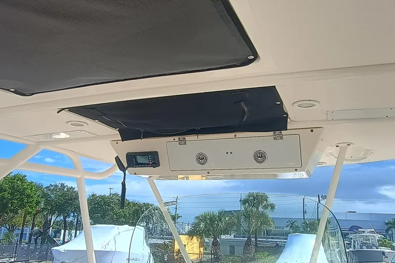 S28-117 Brokerage Joe Yacht Photos Pics 2010 Pursuit S 280 Sport boat interior with electronic controls and overhead storage.