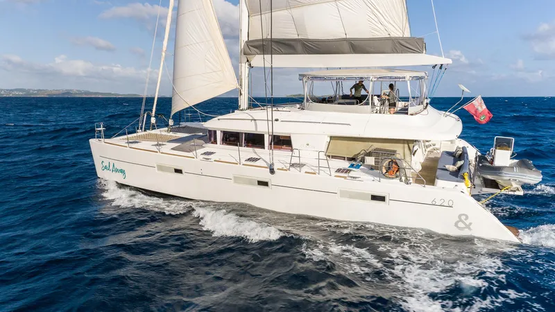  Yacht Photos Pics 2014 Lagoon 620 catamaran sailing on open sea with white sails and clear blue sky.