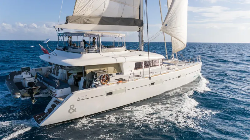  Yacht Photos Pics Luxury Lagoon 620 catamaran sailing on open sea, 2014 model, with full sails.