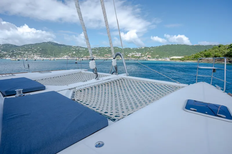  Yacht Photos Pics Catamaran Lagoon 620 (2014) on serene blue waters with lush green hills in the background.