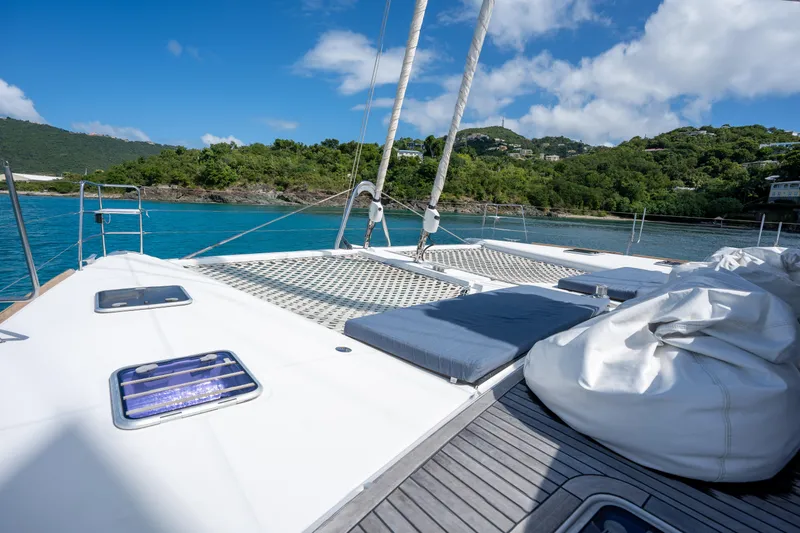  Yacht Photos Pics Luxurious 2014 Lagoon 620 catamaran deck with scenic ocean view and lush green hills.