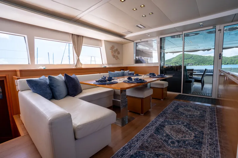  Yacht Photos Pics Luxurious interior of 2014 Lagoon 620 yacht with elegant dining area and scenic views.