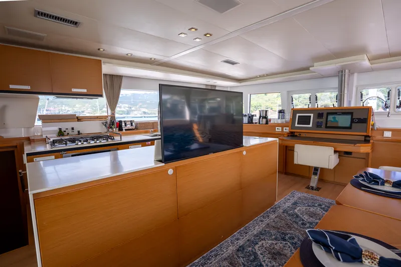  Yacht Photos Pics Luxurious interior of 2014 Lagoon 620 yacht with modern kitchen and entertainment area.