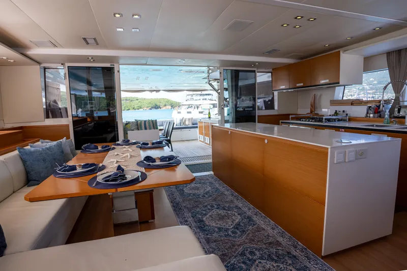 Yacht Photos Pics Luxurious interior of 2014 Lagoon 620 yacht with elegant dining area and modern kitchen.