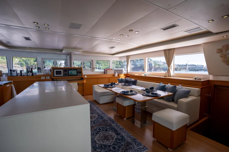 Yacht Photos Pics Luxurious interior of 2014 Lagoon 620 yacht with elegant dining area and panoramic windows.