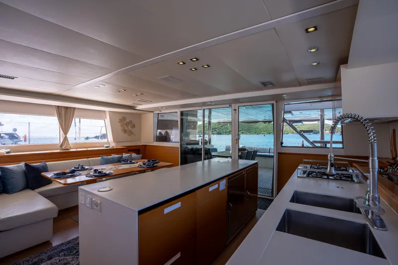  Yacht Photos Pics Luxurious interior of 2014 Lagoon 620 yacht with modern kitchen and dining area.