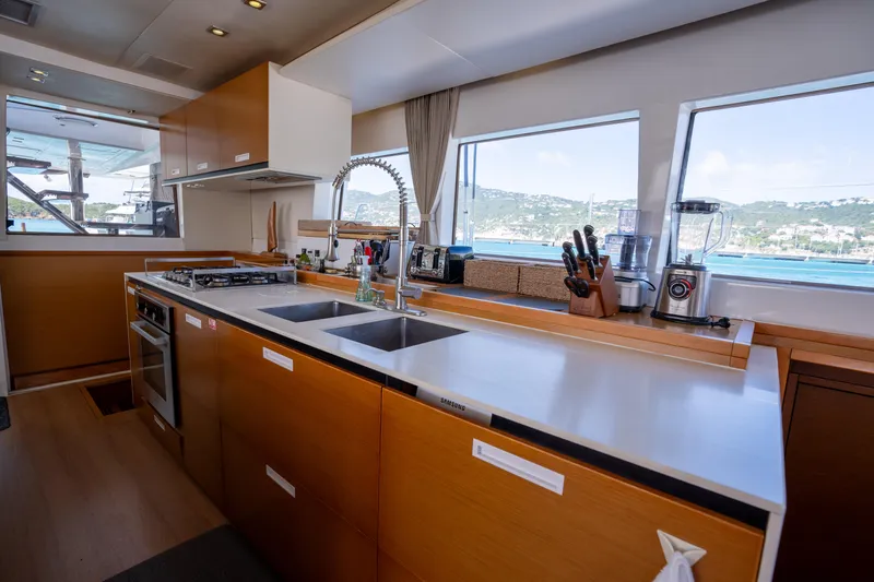 Yacht Photos Pics Modern kitchen interior of 2014 Lagoon 620 yacht with ocean view through large windows.