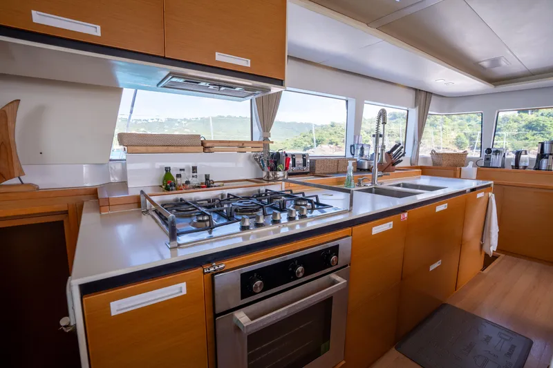  Yacht Photos Pics Modern kitchen interior on a 2014 Lagoon 620 yacht, featuring a stove and ample counter space.