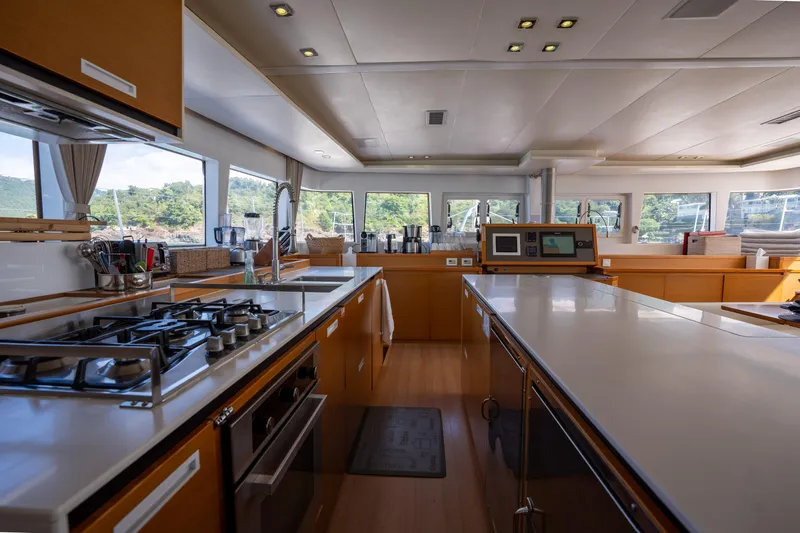  Yacht Photos Pics Spacious kitchen interior of 2014 Lagoon 620 yacht with modern appliances and panoramic windows.