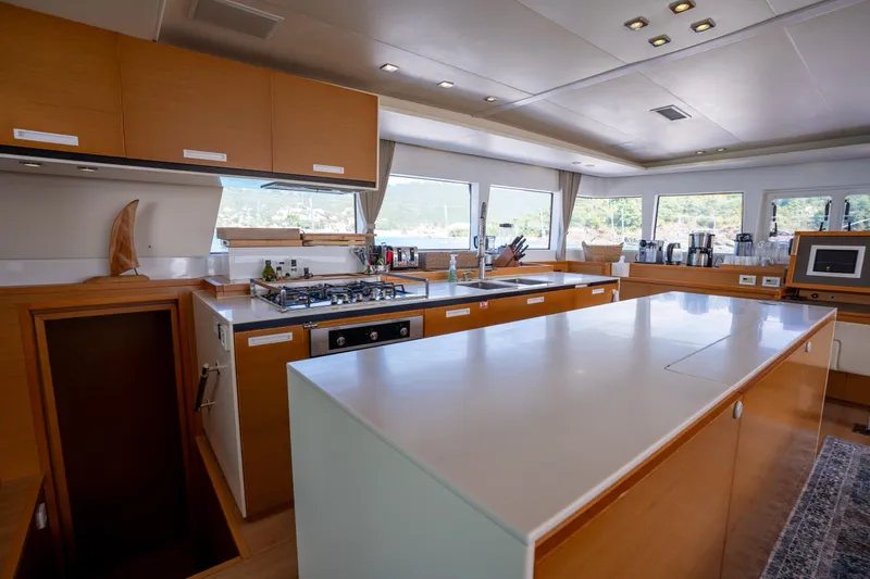  Yacht Photos Pics Spacious kitchen interior of 2014 Lagoon 620 yacht with modern amenities and large windows.